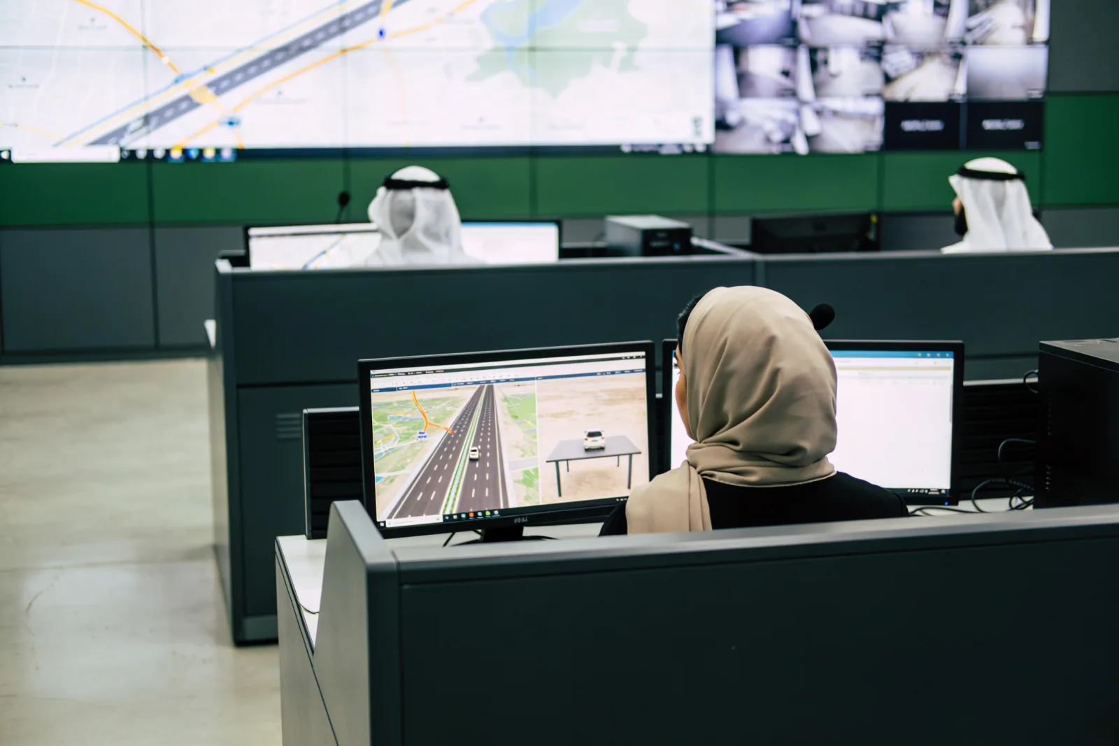 Operators at a traffic control room video wall