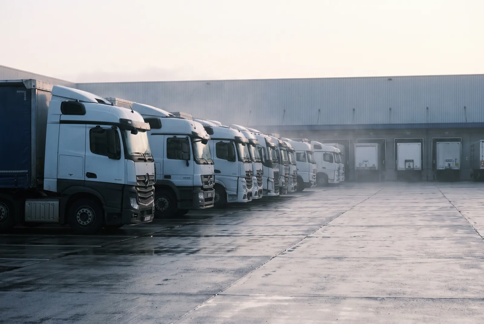 A logistics depot at first light, trailers being loaded